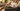 White dad club collective hat with brown brim and logo on a couch with a blanket