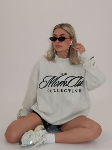 Cool girl wearing a Mom Club Mockneck listening to music in her headphones.