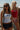 Two women wearing American Sports Club attire standing by a body of water.