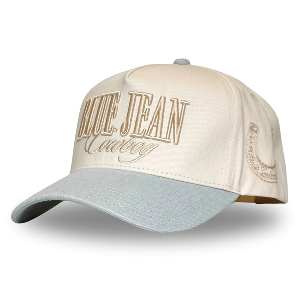 A beige and white trucker hat with 'BLUE JEAN' and 'COUNTRY' embroidery on the front.