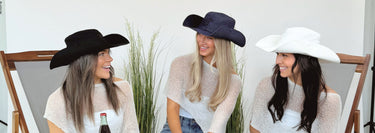 Three girls wearing black, denim, and white cowboy bucket hats
