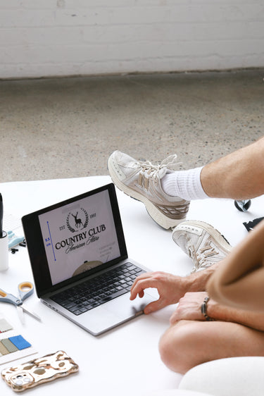 a person designing a custom trucker hat on a computer