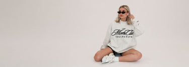 Cool girl wearing a Mom Club Mockneck listening to music in her headphones.